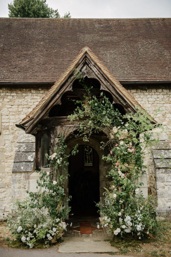 Wild asymmetric floral arch in Surrey